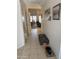 Inviting hallway with tile flooring and neutral walls, leading to the living and dining areas at 402 W Grandview Rd, Phoenix, AZ 85023