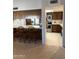 Open kitchen with modern appliances, a breakfast bar, and a seamless flow into the adjacent living spaces at 402 W Grandview Rd, Phoenix, AZ 85023