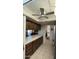 Kitchen featuring wood cabinets, tile countertops, and a view into the dining and living areas at 402 W Grandview Rd, Phoenix, AZ 85023