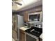 Functional kitchen featuring stainless steel appliances, modern fixtures, and ample cabinet space at 402 W Grandview Rd, Phoenix, AZ 85023