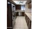Modern kitchen with stainless steel appliances, light countertops, and wood cabinets at 402 W Grandview Rd, Phoenix, AZ 85023