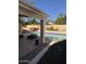 Outdoor pool with a covered patio, surrounded by a block wall and manicured landscaping at 402 W Grandview Rd, Phoenix, AZ 85023