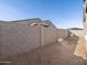 New construction home featuring a spacious backyard with a privacy block fence at 16039 W Desert Hollow Dr, Surprise, AZ 85379