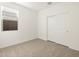 Bedroom features a large window, closet, and carpet flooring at 16039 W Desert Hollow Dr, Surprise, AZ 85379