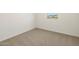 Empty bedroom has neutral carpet and a small window at 16039 W Desert Hollow Dr, Surprise, AZ 85379