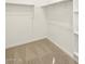 Walk-in closet with shelving and hanging rods at 16039 W Desert Hollow Dr, Surprise, AZ 85379