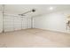 Spacious garage with concrete flooring and white walls at 16039 W Desert Hollow Dr, Surprise, AZ 85379