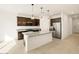 Charming kitchen with granite countertops, stainless steel appliances, and island with breakfast bar at 16039 W Desert Hollow Dr, Surprise, AZ 85379