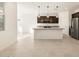 Bright, open-concept kitchen featuring granite countertops, stainless steel appliances, and a large island at 16039 W Desert Hollow Dr, Surprise, AZ 85379