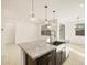 Bright kitchen with granite counters, stainless steel appliances, and a spacious island with pendant lighting at 16039 W Desert Hollow Dr, Surprise, AZ 85379