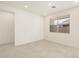 Bright, airy living room with tile flooring, recessed lighting, and window providing natural light at 16039 W Desert Hollow Dr, Surprise, AZ 85379