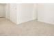 An open-concept living area with neutral flooring and bright white walls and ample natural light at 16039 W Desert Hollow Dr, Surprise, AZ 85379
