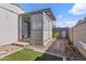 Backyard patio cover with artificial grass area and easy to maintain desert landscaping at 11275 N 99Th Ave # 145, Peoria, AZ 85345