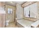 Bathroom featuring neutral flooring, floral wallpaper, and soaking tub under a large picture window at 11275 N 99Th Ave # 145, Peoria, AZ 85345
