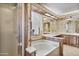 Well-lit bathroom features a soaking tub, glass shower, and decorative floral wallpaper at 11275 N 99Th Ave # 145, Peoria, AZ 85345