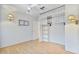 Bedroom with neutral walls, ceiling fan, laminate floors, closet with built-in shelves, and decorative wall lamps at 11275 N 99Th Ave # 145, Peoria, AZ 85345