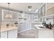 Bright kitchen featuring light countertops, gray cabinetry, gas stove, stainless vent hood, and modern backsplash at 11275 N 99Th Ave # 145, Peoria, AZ 85345