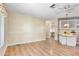 Spacious living room featuring laminate wood flooring, decorative painted walls, and views into the kitchen at 11275 N 99Th Ave # 145, Peoria, AZ 85345