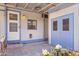 Cozy covered patio with a blue trimmed exterior door and outdoor storage at 11275 N 99Th Ave # 145, Peoria, AZ 85345