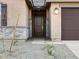 Close-up of the front door with stone veneer accents and a covered entryway at 22455 W Pontiac Dr, Surprise, AZ 85387