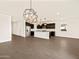 Open-concept kitchen with stainless steel appliances, a large island, and dark wood cabinets for a modern aesthetic at 22455 W Pontiac Dr, Surprise, AZ 85387
