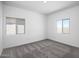 Bedroom with two windows offering bright natural light and neutral carpeting at 24592 W St Anne Ave, Buckeye, AZ 85326