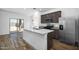 Modern kitchen with an island, stainless appliances, and outdoor access at 24592 W St Anne Ave, Buckeye, AZ 85326