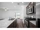 Modern kitchen features stainless steel appliances, center island and views to the outdoor space at 24592 W St Anne Ave, Buckeye, AZ 85326