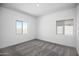 Clean bedroom with carpet floors and two windows at 24593 W St Catherine Ave, Buckeye, AZ 85326
