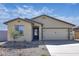 Charming single-story home with desert landscaping, a two-car garage, and a welcoming blue front door at 24593 W St Catherine Ave, Buckeye, AZ 85326