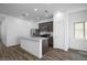 Bright, open kitchen area with stainless steel appliances, granite countertops and a center island at 24593 W St Catherine Ave, Buckeye, AZ 85326