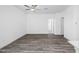 Open-concept living room with wood-look flooring and a ceiling fan at 24593 W St Catherine Ave, Buckeye, AZ 85326