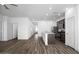 Bright living area with wood-look flooring leading into kitchen at 24593 W St Catherine Ave, Buckeye, AZ 85326