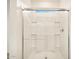 Clean shower with glass enclosure and built-in shelving at 36986 W Prado St, Maricopa, AZ 85138