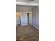 Hallway featuring wood look floors, multiple doorways, and neutral paint at 43603 N 44Th Ln, Phoenix, AZ 85087
