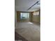 Expansive living room featuring neutral carpet, accent lighting, and bright window at 43603 N 44Th Ln, Phoenix, AZ 85087