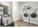 Laundry room featuring washer, dryer, and ample storage at 9447 W Patrick Ln, Peoria, AZ 85383