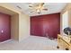 Small office or den with dark-red accent wall and ceiling fan at 15101 W Waterford Dr, Surprise, AZ 85374