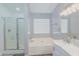 Bathroom with double vanity, soaking tub, shower, and neutral decor at 22264 N Kingston Dr, Maricopa, AZ 85138