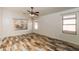Bright bedroom with wood-look flooring, multiple windows, and ample natural light at 22264 N Kingston Dr, Maricopa, AZ 85138
