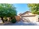 Charming single-story home with a two-car garage and mature trees in a well-maintained community at 22264 N Kingston Dr, Maricopa, AZ 85138