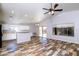 Spacious living room features a ceiling fan, wood-look flooring, and access to the backyard at 22264 N Kingston Dr, Maricopa, AZ 85138