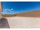 Large, empty backyard framed by a solid brick wall, presenting a blank canvas for landscaping at 18532 E Dario Rd, Gold Canyon, AZ 85118