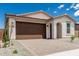 Charming single-story home with a well-manicured front yard and a brown garage door at 18532 E Dario Rd, Gold Canyon, AZ 85118