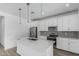 Modern kitchen with stainless steel appliances, white cabinets and a center island at 18532 E Dario Rd, Gold Canyon, AZ 85118