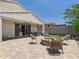 Relaxing backyard with a covered patio, fire pit, and an outdoor dining area perfect for entertaining guests at 10637 W Eucalyptus Rd, Peoria, AZ 85383