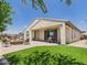 Spacious backyard featuring a covered patio, dining area, artificial turf, and a cozy fire pit at 10637 W Eucalyptus Rd, Peoria, AZ 85383
