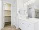 Bright bathroom with walk-in closet and vanity with cabinets for storage at 10637 W Eucalyptus Rd, Peoria, AZ 85383