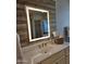 Stylish bathroom vanity with a modern, lighted mirror and decorative wood paneling at 10637 W Eucalyptus Rd, Peoria, AZ 85383