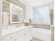 Bright bathroom featuring a soaking tub, glass enclosed shower and a wood accent wall at 10637 W Eucalyptus Rd, Peoria, AZ 85383